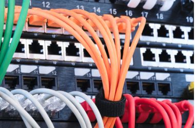 Structured cabling with Ethernet patch cords connected to a network switch for high-speed data and audio transmission in datacom systems.